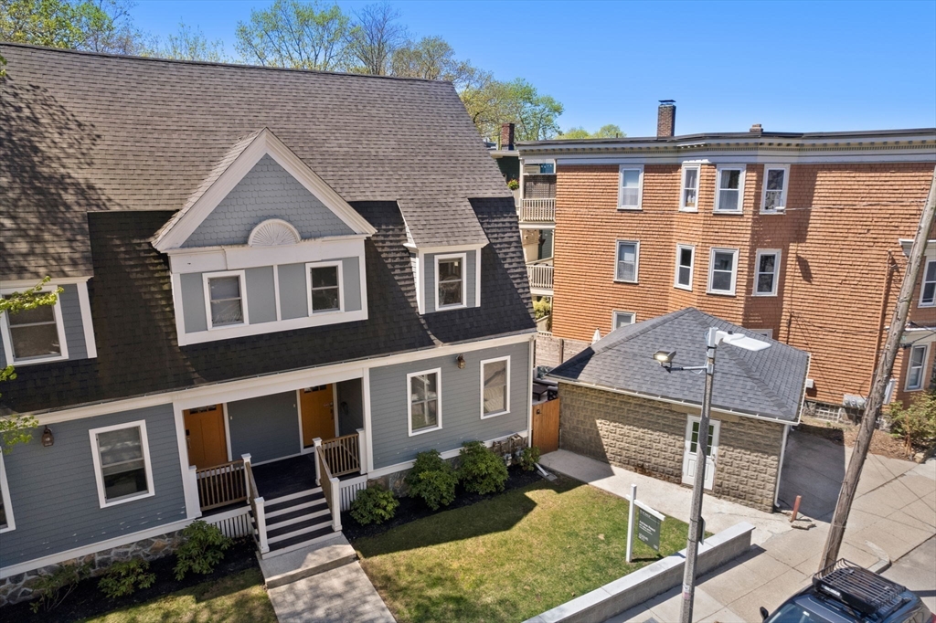 91 Glen Road, Unit 2 Boston, MA 02130 - Photo 22 of 31 a front view of a house with a yard