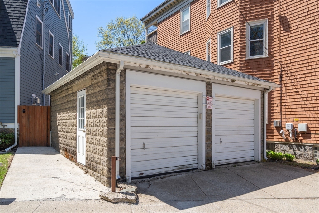 91 Glen Road, Unit 2 Boston, MA 02130 - Photo 23 of 31 a front view of a house with a garage