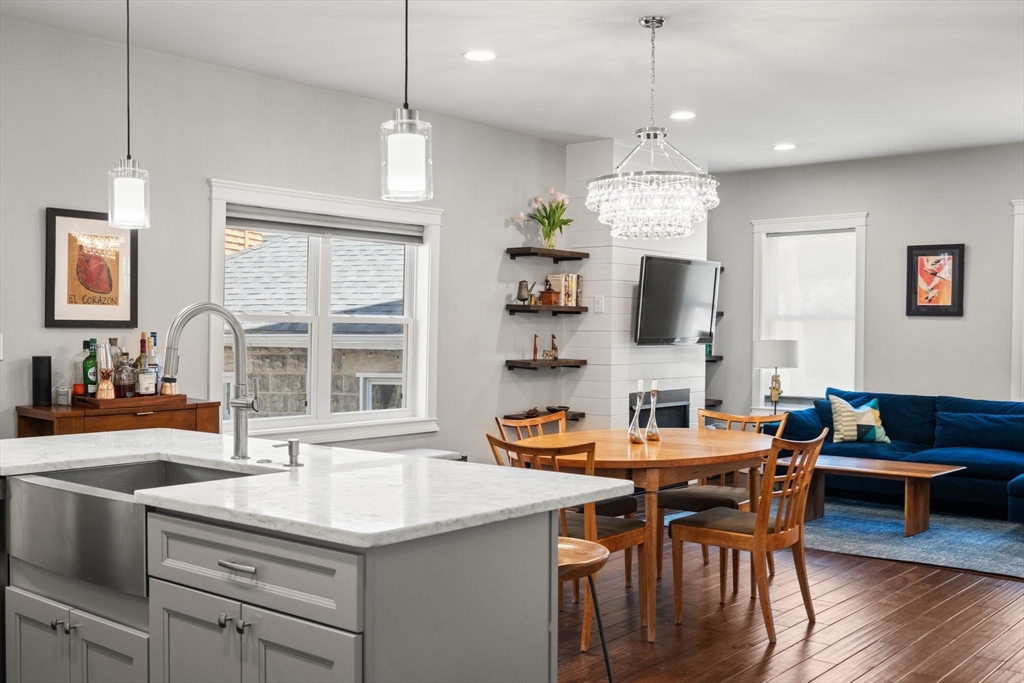 91 Glen Road, Unit 2 Boston, MA 02130 - Photo 3 of 31 a kitchen with a sink stove a dining table and chairs