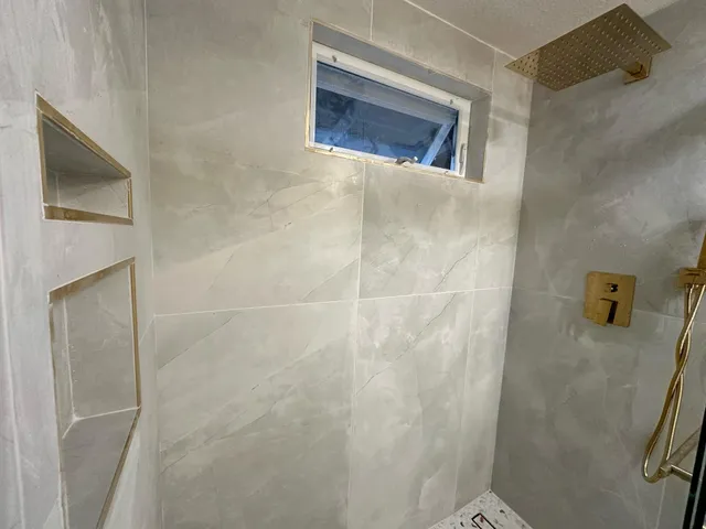 a bathroom with a shower and a sink