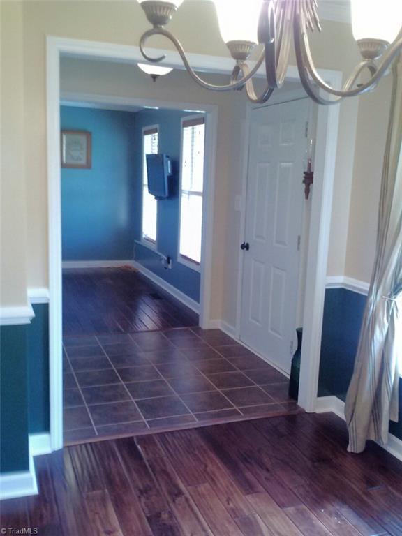 153 Winchester Road Advance, NC 27006 - Photo 15 of 20 Hardwood floors in dining room, tile in foyer and hardwood in office/living room