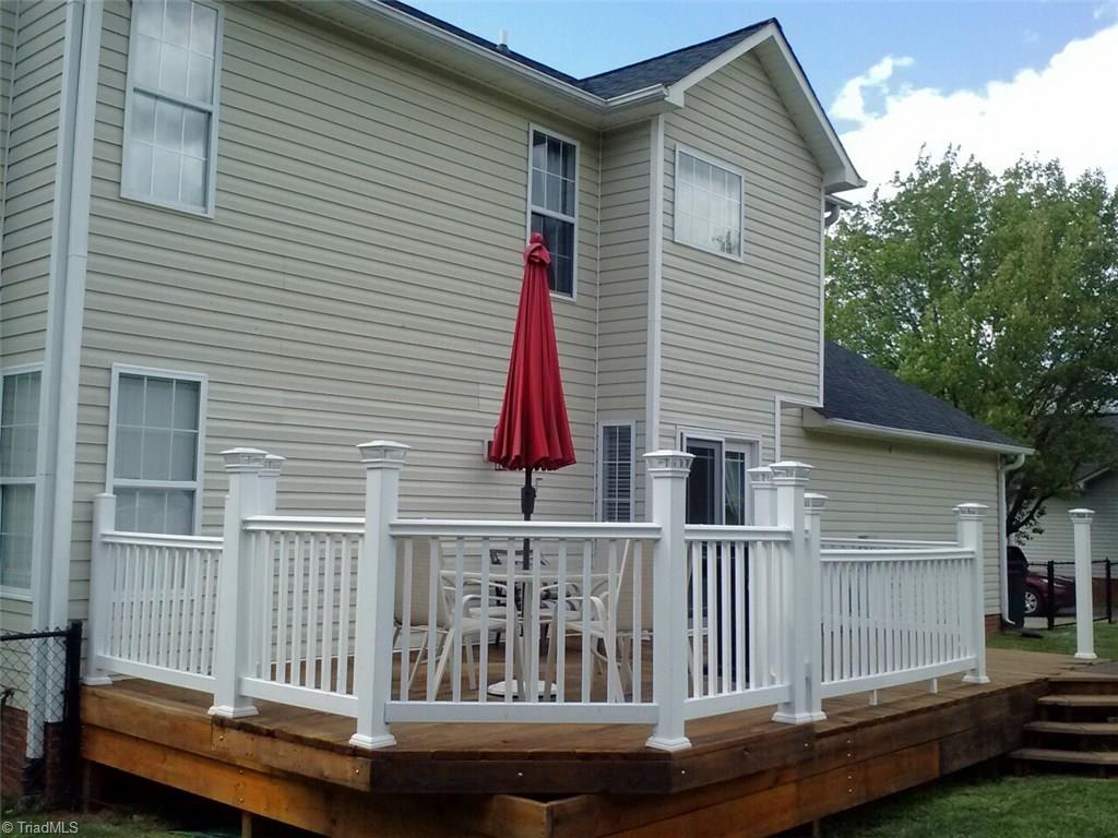 153 Winchester Road Advance, NC 27006 - Photo 6 of 20 Rear with raised deck. Connects to bridge that leads to the pool.