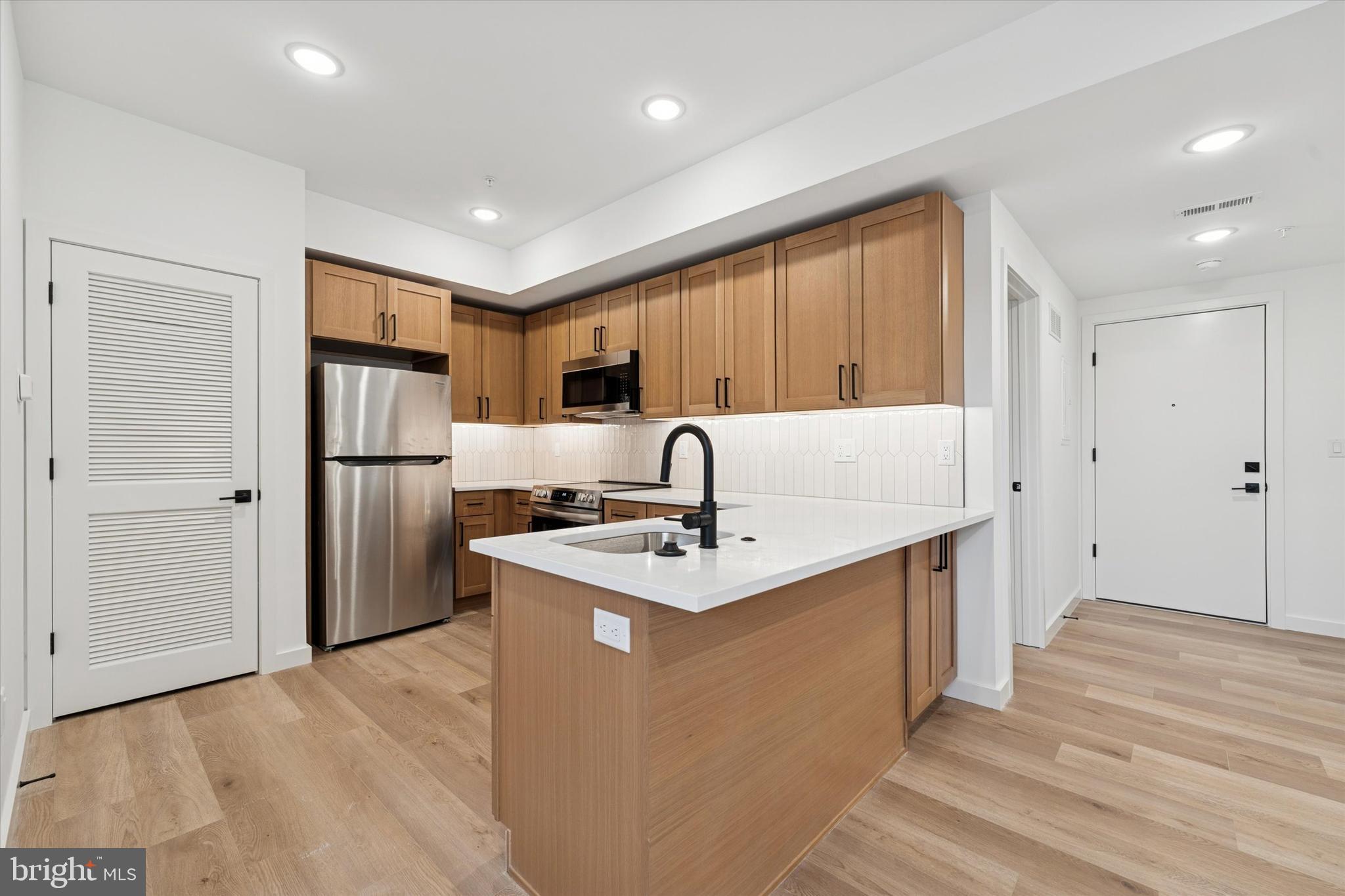754 South 4th Street, Unit 202 Philadelphia, PA 19147 - Photo 2 of 10 a kitchen with stainless steel appliances granite countertop a sink stove and refrigerator