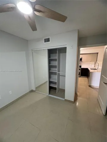 an empty room with a fireplace and windows
