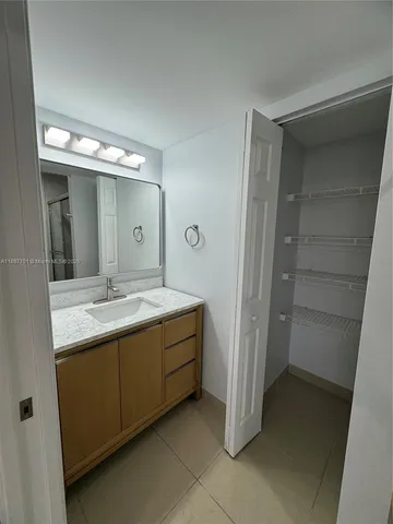 a bathroom with a double vanity sink and a mirror