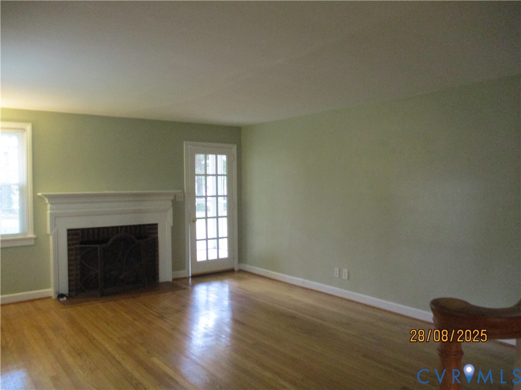 Undisclosed Address Hanover, VA 23069 - Photo 4 of 19 an empty room with wooden floor fireplace and windows