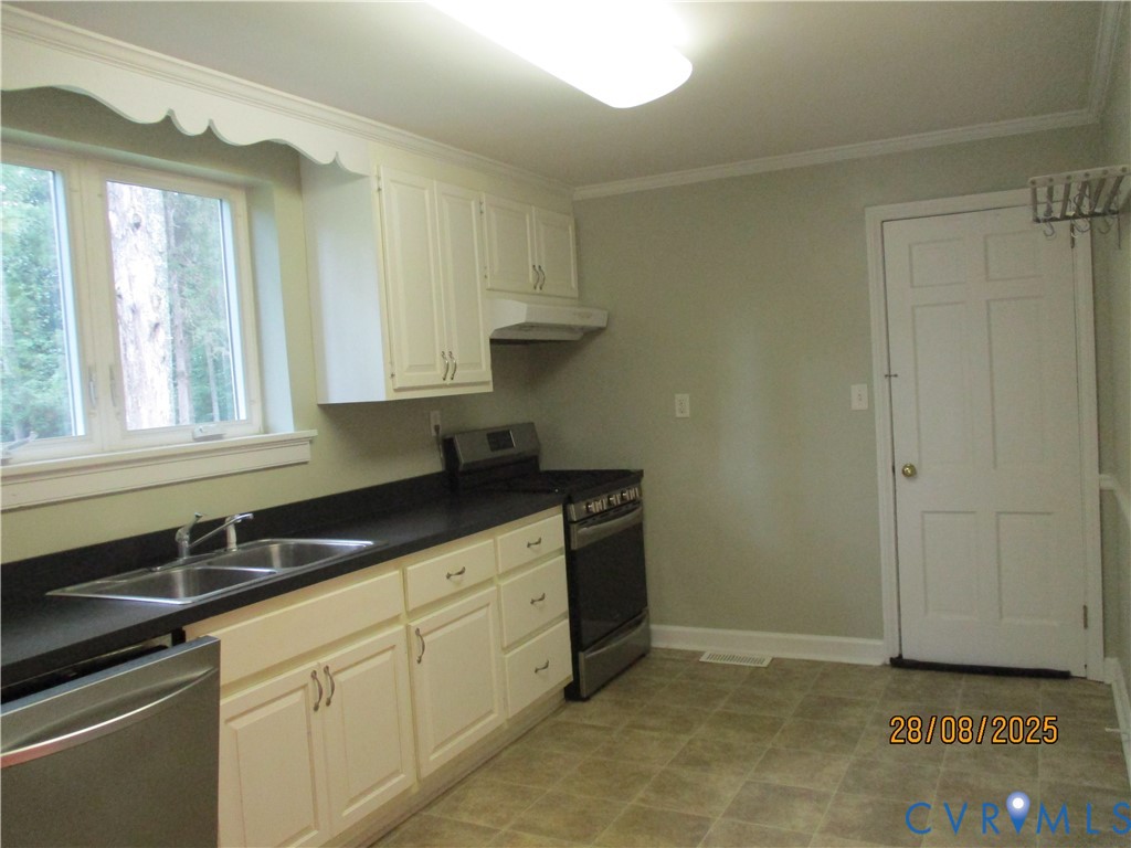 Undisclosed Address Hanover, VA 23069 - Photo 7 of 19 a kitchen with granite countertop a sink a stove and cabinets