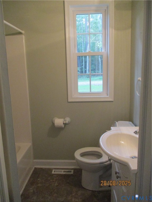 Undisclosed Address Hanover, VA 23069 - Photo 9 of 19 a white toilet sitting next to a bathroom sink