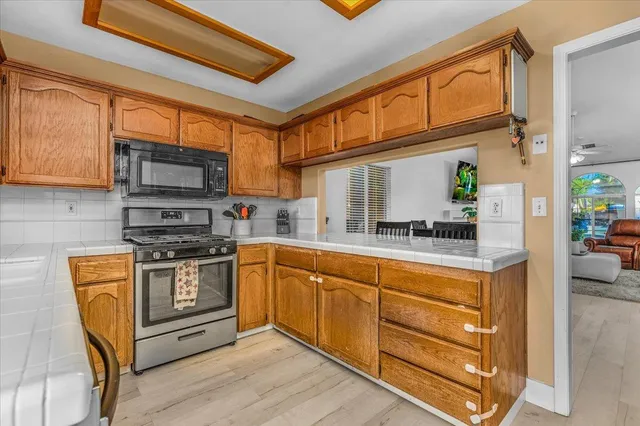 a kitchen with stainless steel appliances granite countertop a refrigerator and a sink