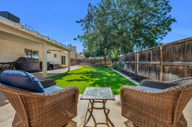 a view of a house with backyard sitting area and garden