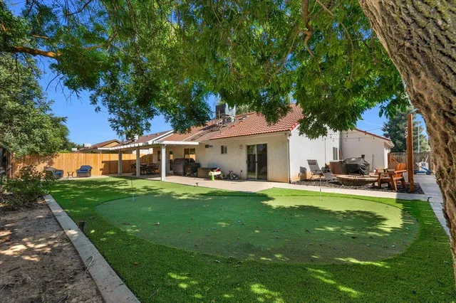 a view of a house with a yard and sitting area