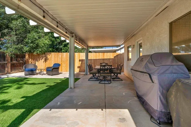 a view of a patio with chairs and table in the patio
