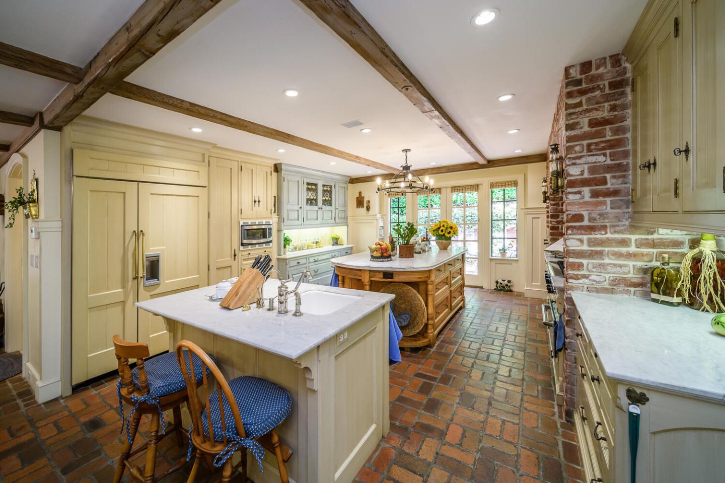 100 Robin Road Hillsborough, CA 94010 - Photo 13 of 90 a dining hall with stainless steel appliances a dining table and chairs with wooden floor