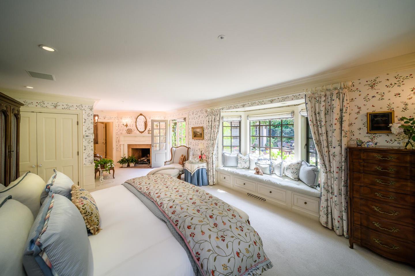 100 Robin Road Hillsborough, CA 94010 - Photo 22 of 90 a spacious bedroom with a large bed and a flat tv screen