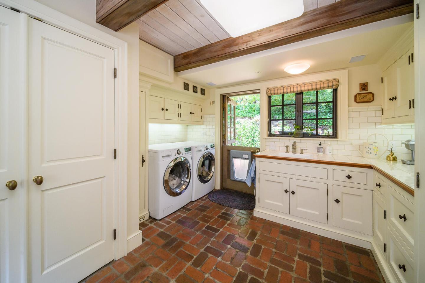 100 Robin Road Hillsborough, CA 94010 - Photo 32 of 90 a spacious bathroom with a double vanity sink a mirror a bathtub and window