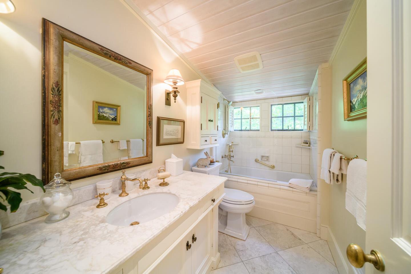100 Robin Road Hillsborough, CA 94010 - Photo 45 of 90 a bathroom with a double vanity sink a toilet and a mirror