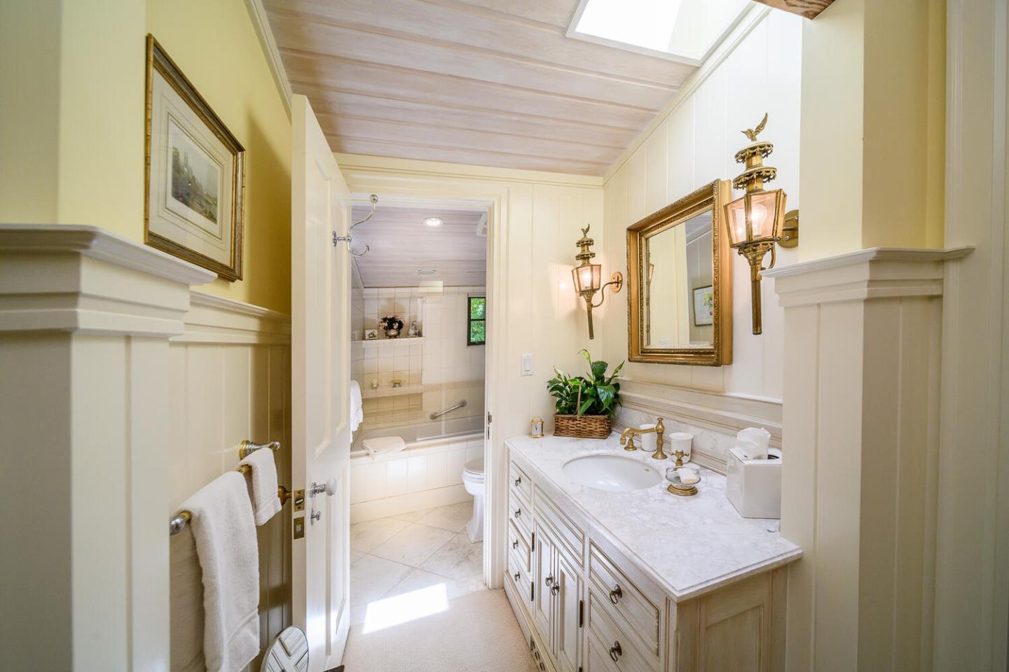 100 Robin Road Hillsborough, CA 94010 - Photo 47 of 90 a bathroom with a sink a mirror and a shower