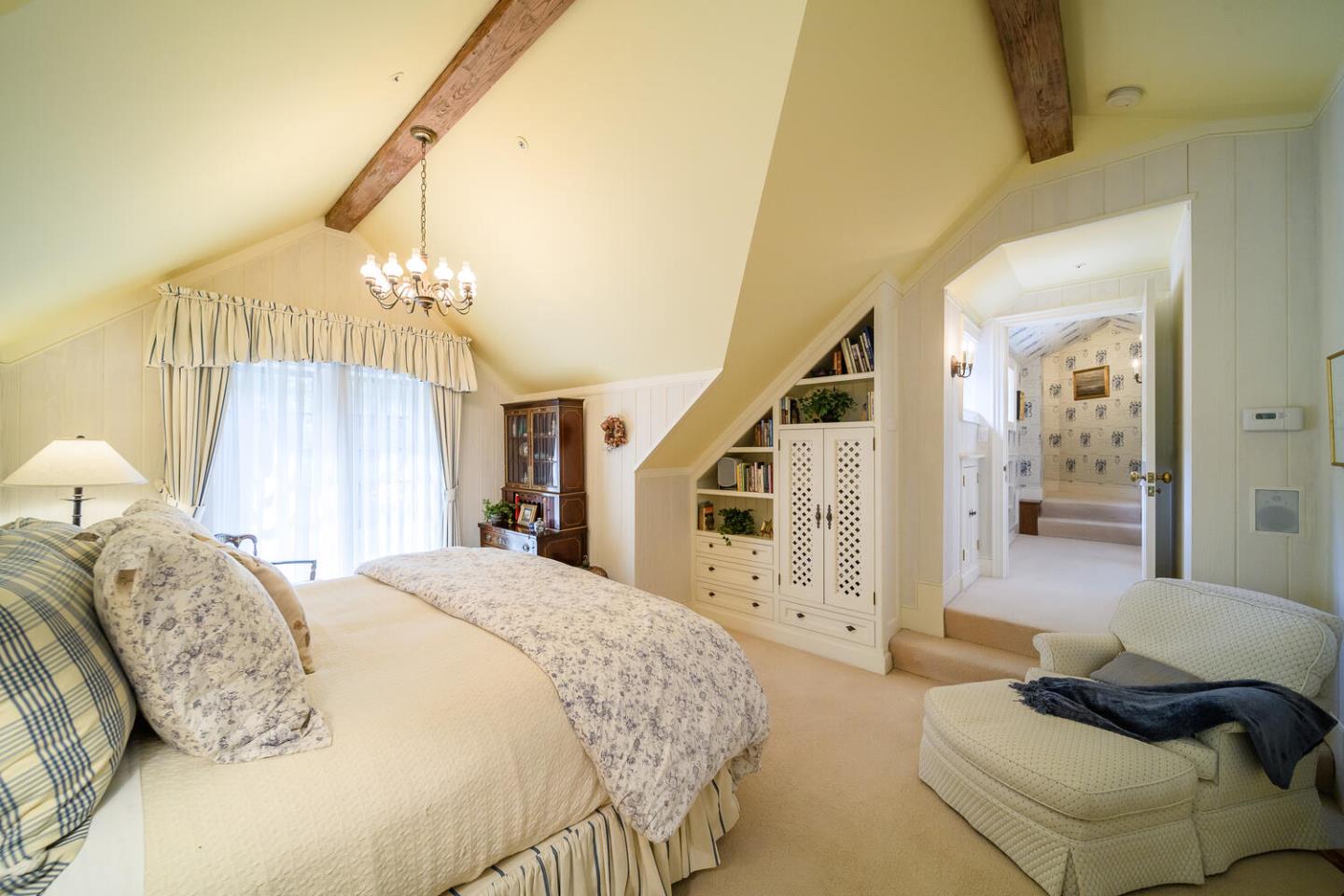 100 Robin Road Hillsborough, CA 94010 - Photo 50 of 90 a spacious bedroom with a bed a chandelier and a couch