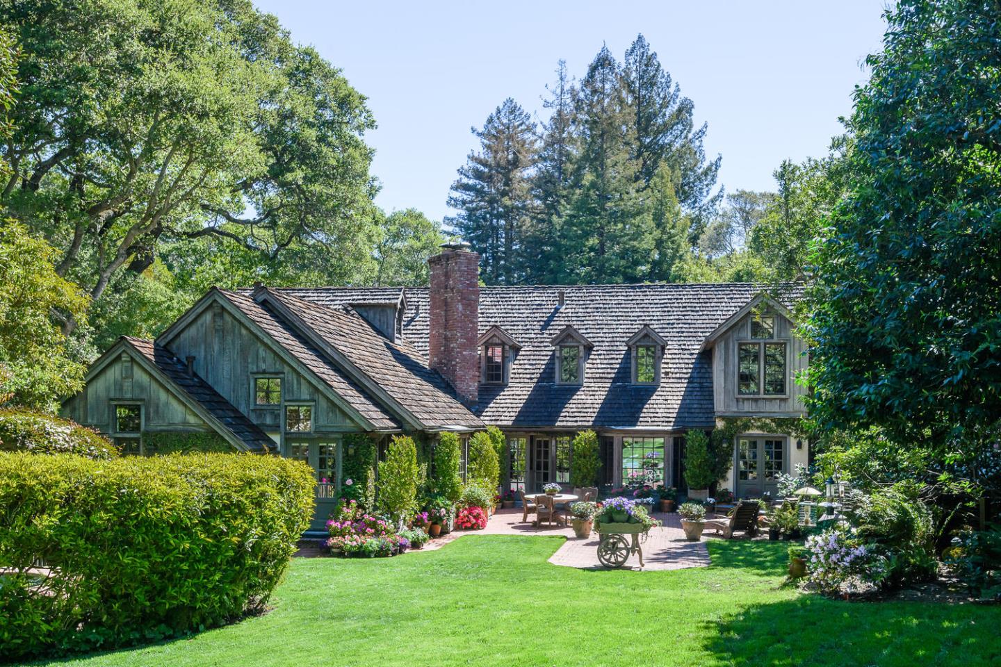 100 Robin Road Hillsborough, CA 94010 - Photo 58 of 90 a view of a patio with table and chairs potted plants and large tree
