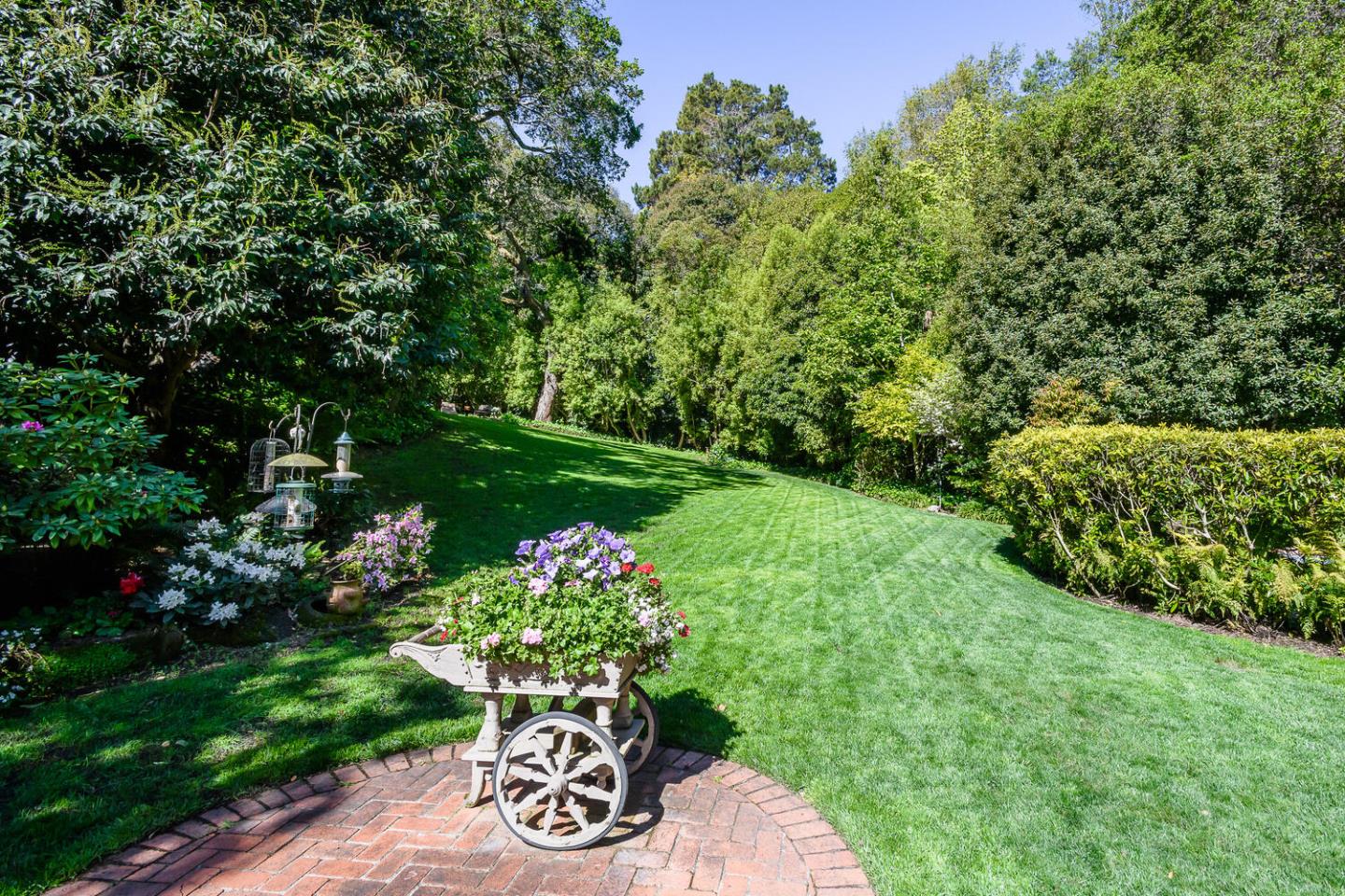100 Robin Road Hillsborough, CA 94010 - Photo 63 of 90 a view of a garden with a lot of flower plants and wooden fence