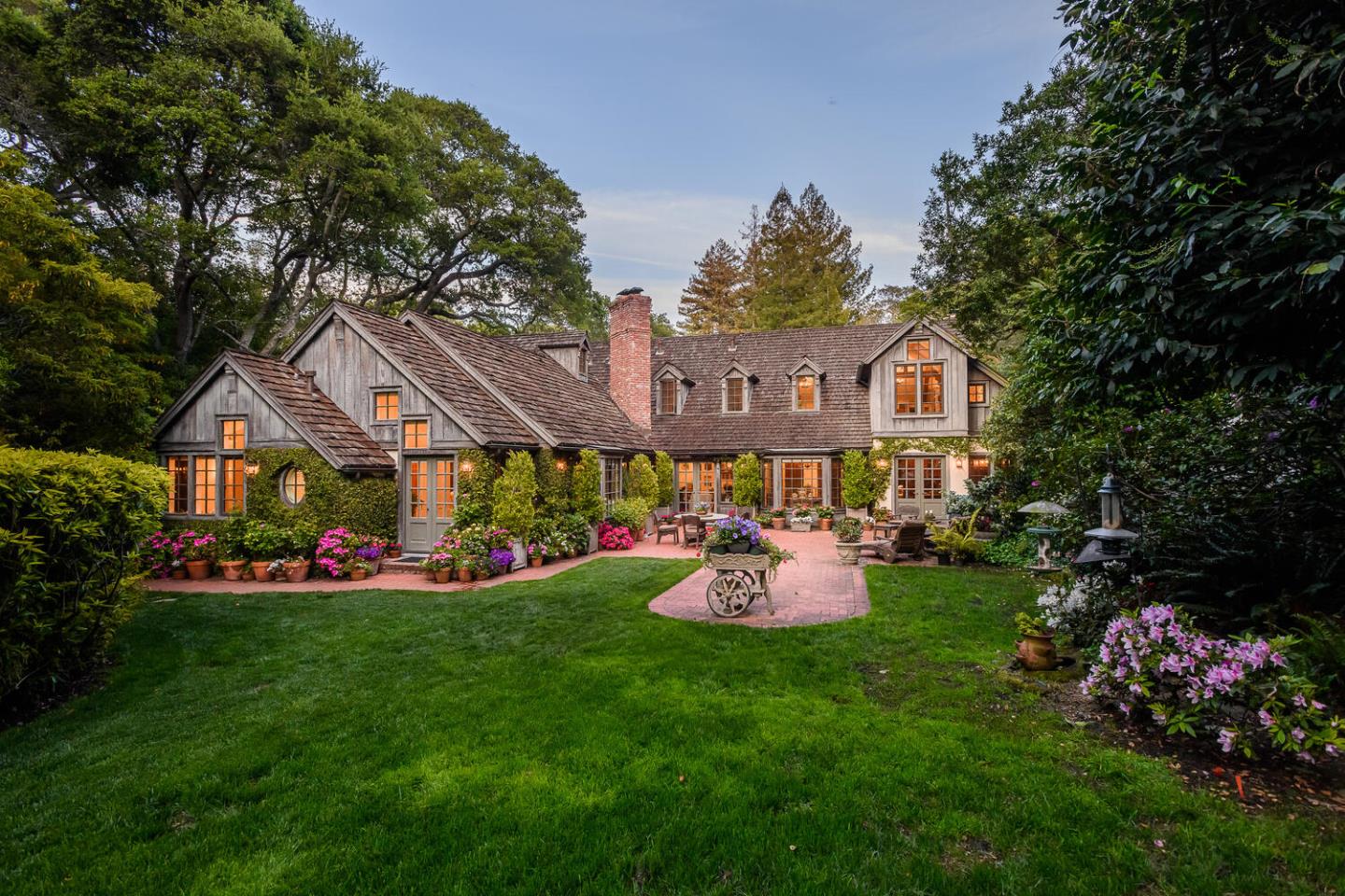 100 Robin Road Hillsborough, CA 94010 - Photo 73 of 90 a front view of a house with a big yard and potted plants