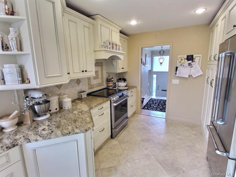 3421 Turf Road Oceanside, NY 11572 - Photo 35 of 50 a kitchen with stainless steel appliances granite countertop a refrigerator sink and stove