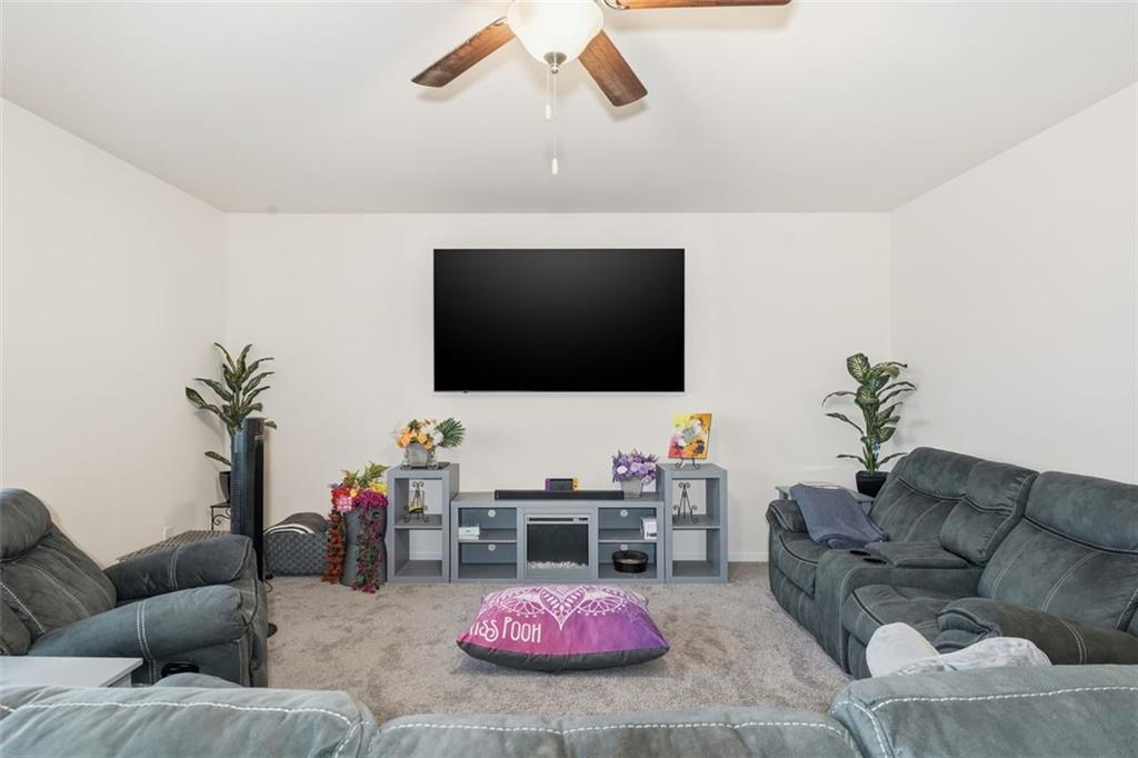 223 Malbone Street Southwest Cartersville, GA 30120 - Photo 12 of 38 a living room with furniture and a flat screen tv