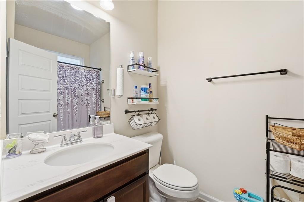 223 Malbone Street Southwest Cartersville, GA 30120 - Photo 15 of 38 a bathroom with a sink a toilet a shower and a mirror