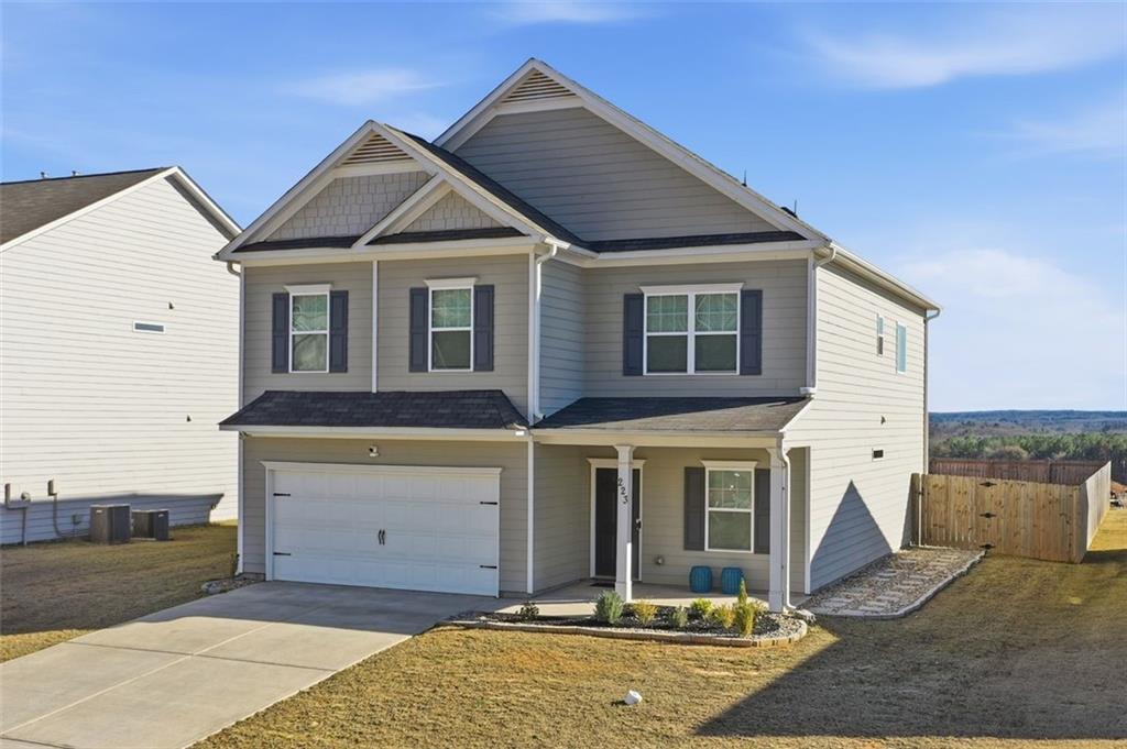 223 Malbone Street Southwest Cartersville, GA 30120 - Photo 2 of 38 a view of a white house with large windows