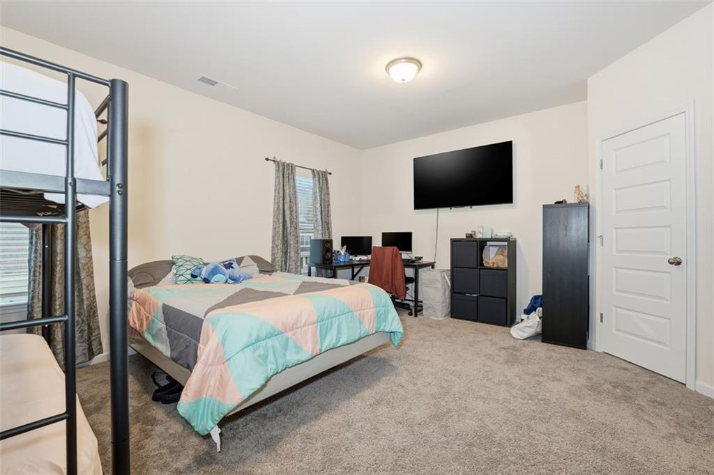 223 Malbone Street Southwest Cartersville, GA 30120 - Photo 25 of 38 a bedroom with a bed and a television in it