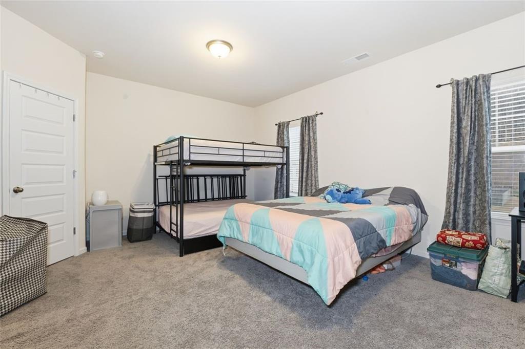 223 Malbone Street Southwest Cartersville, GA 30120 - Photo 26 of 38 a bedroom with a bed and a window