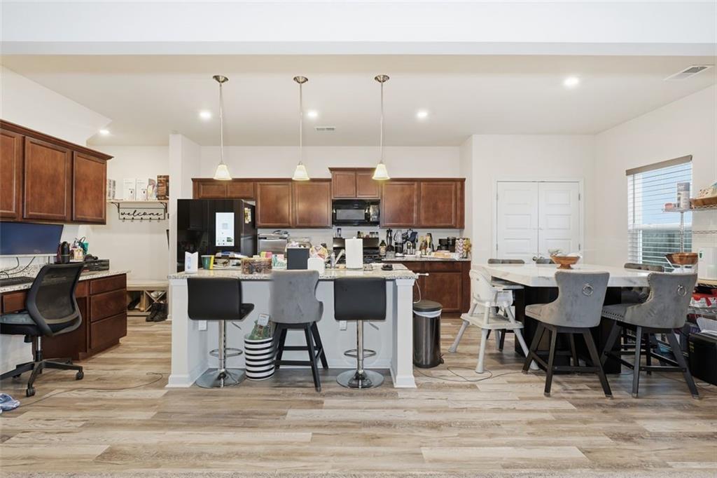 223 Malbone Street Southwest Cartersville, GA 30120 - Photo 10 of 38 a kitchen with a dining table chairs and view living room