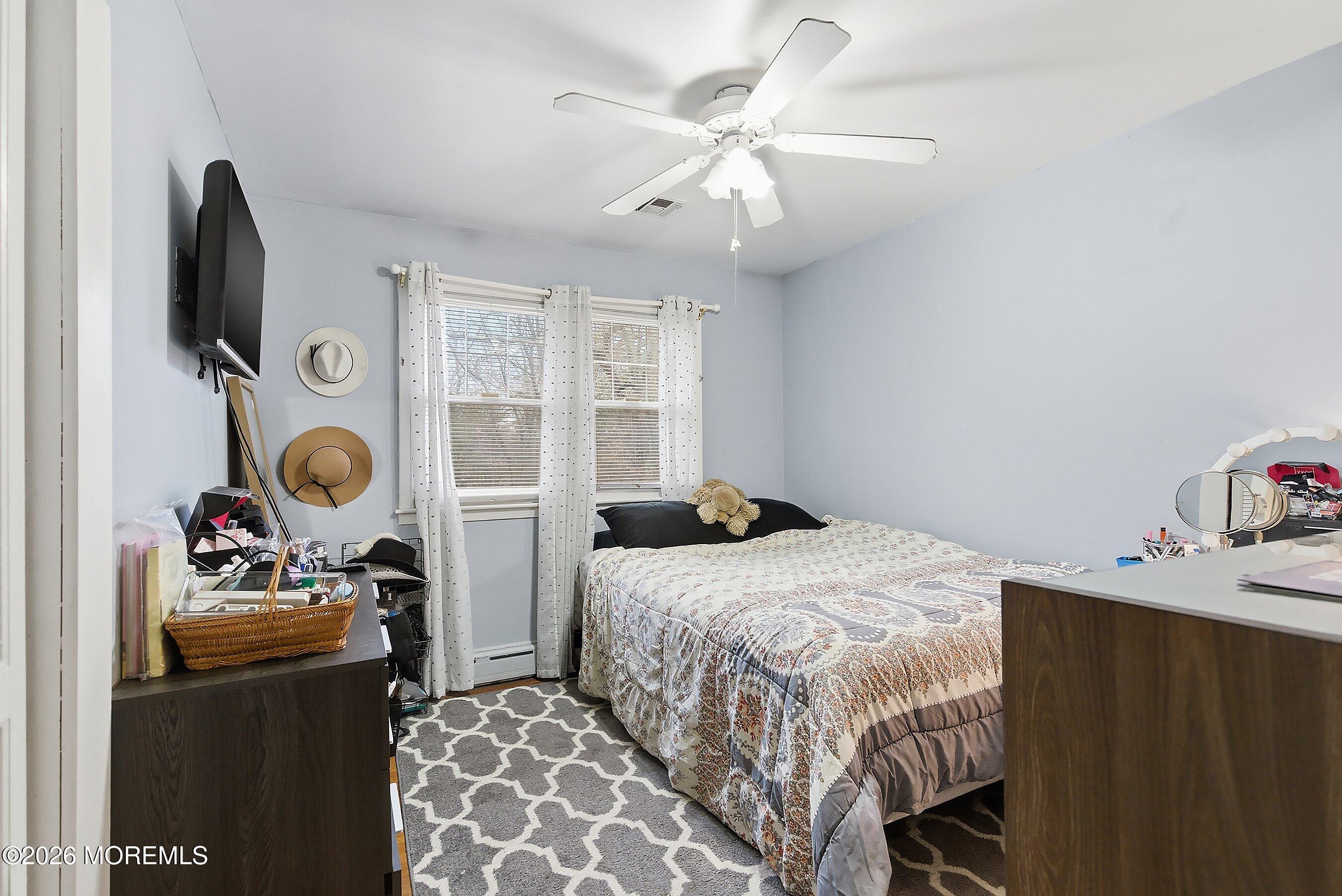 546 Princess Court Toms River, NJ 08753 - Photo 9 of 14 a bedroom with a bed and a chandelier