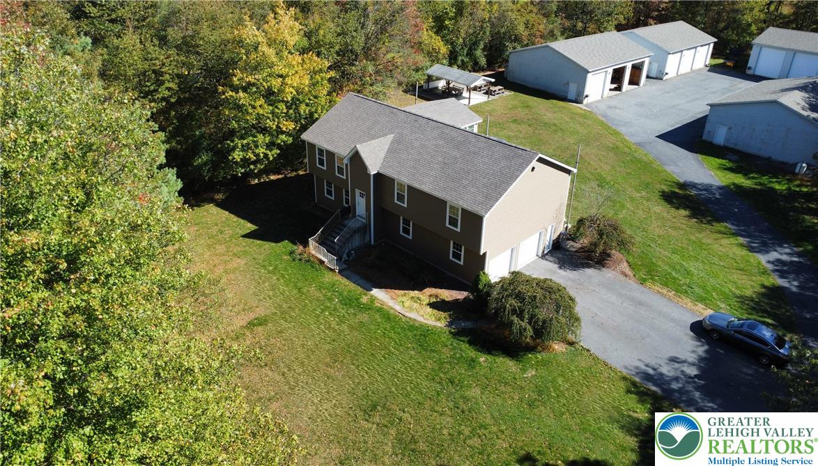 a aerial view of a house with a yard and garage