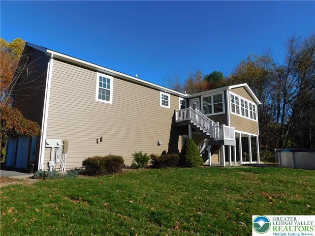 an empty room with a window and a ceiling fan