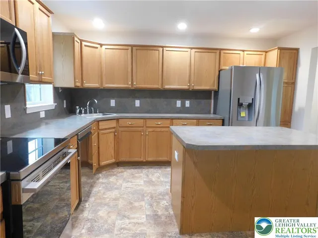 a view of a bench sitting in the grass