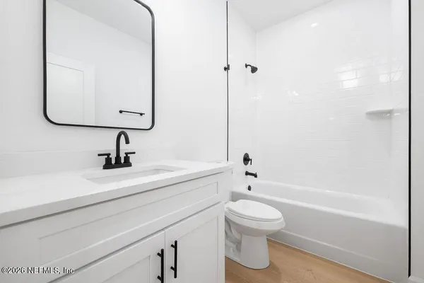 a bathroom with a sink a toilet and a bathtub