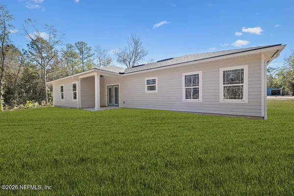 a view of a house with a backyard
