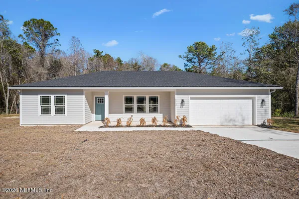 a front view of a house with a porch and a yard