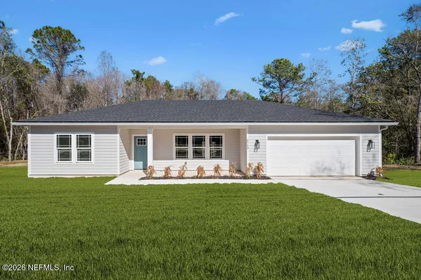 a house view with a sitting space and garden