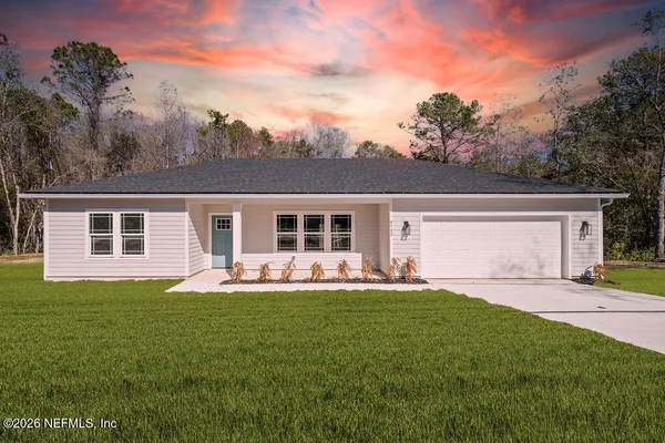 a front view of house with yard and green space