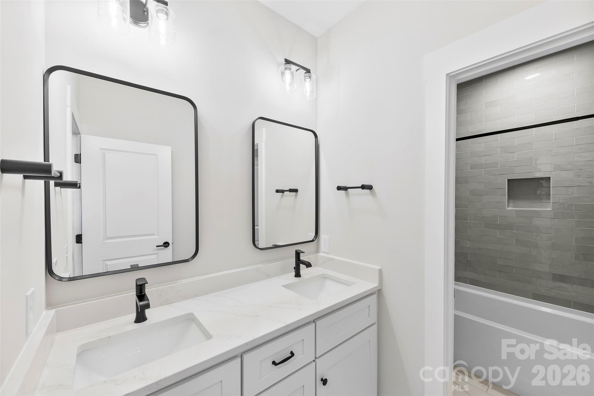 551 Perry Road Troutman, NC 28166 - Photo 36 of 47 a bathroom with double vanity sinks and a shower