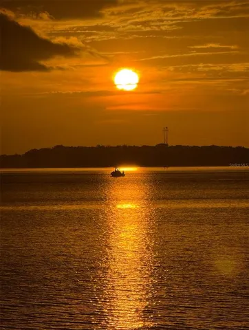 a view of a lake with houses in the back