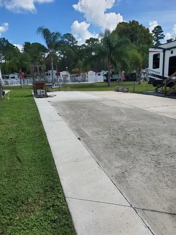 a view of a patio with dining table and chairs with a yard