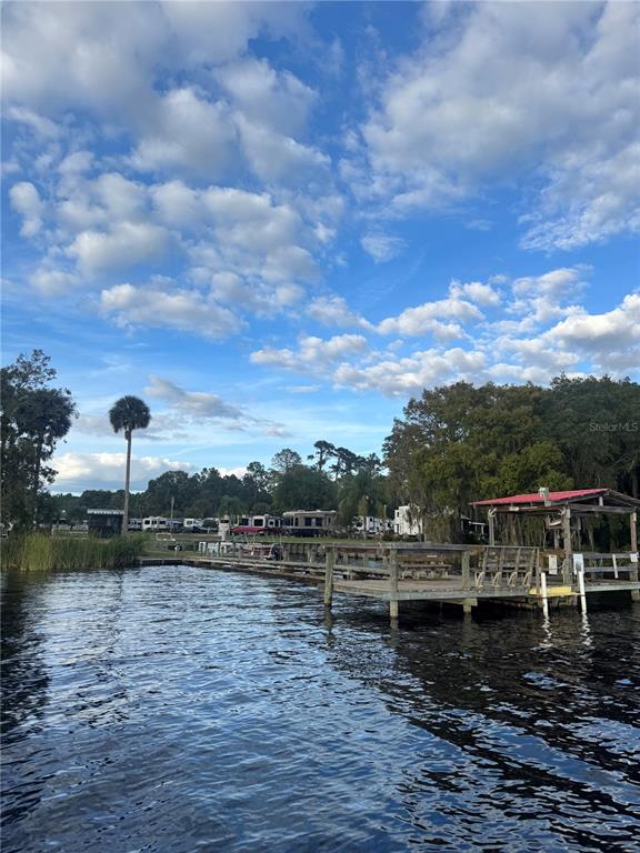 1074 Front Street, Unit 51 Welaka, FL 32193 - Photo 21 of 27 a view of a lake with houses in the back