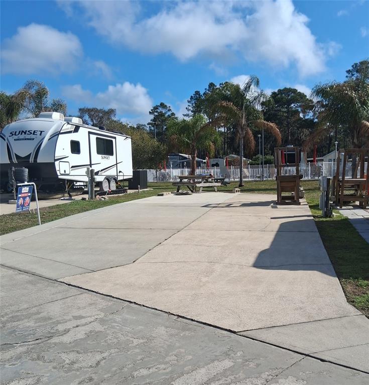 1074 Front Street, Unit 51 Welaka, FL 32193 - Photo 3 of 27 a swimming pool with outdoor seating and yard