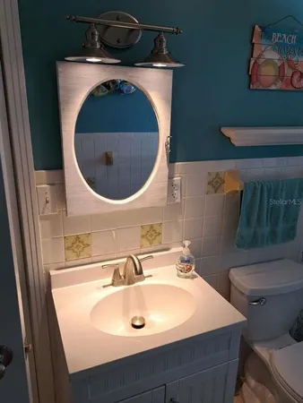 a bathroom with a sink and mirror