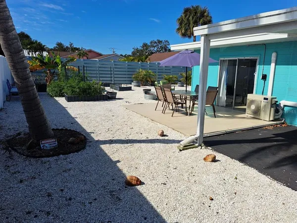 a view of a backyard with plants and patio