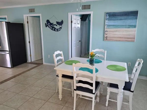 a dining room with furniture and window