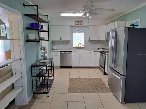 a kitchen with stainless steel appliances granite countertop a refrigerator and microwave